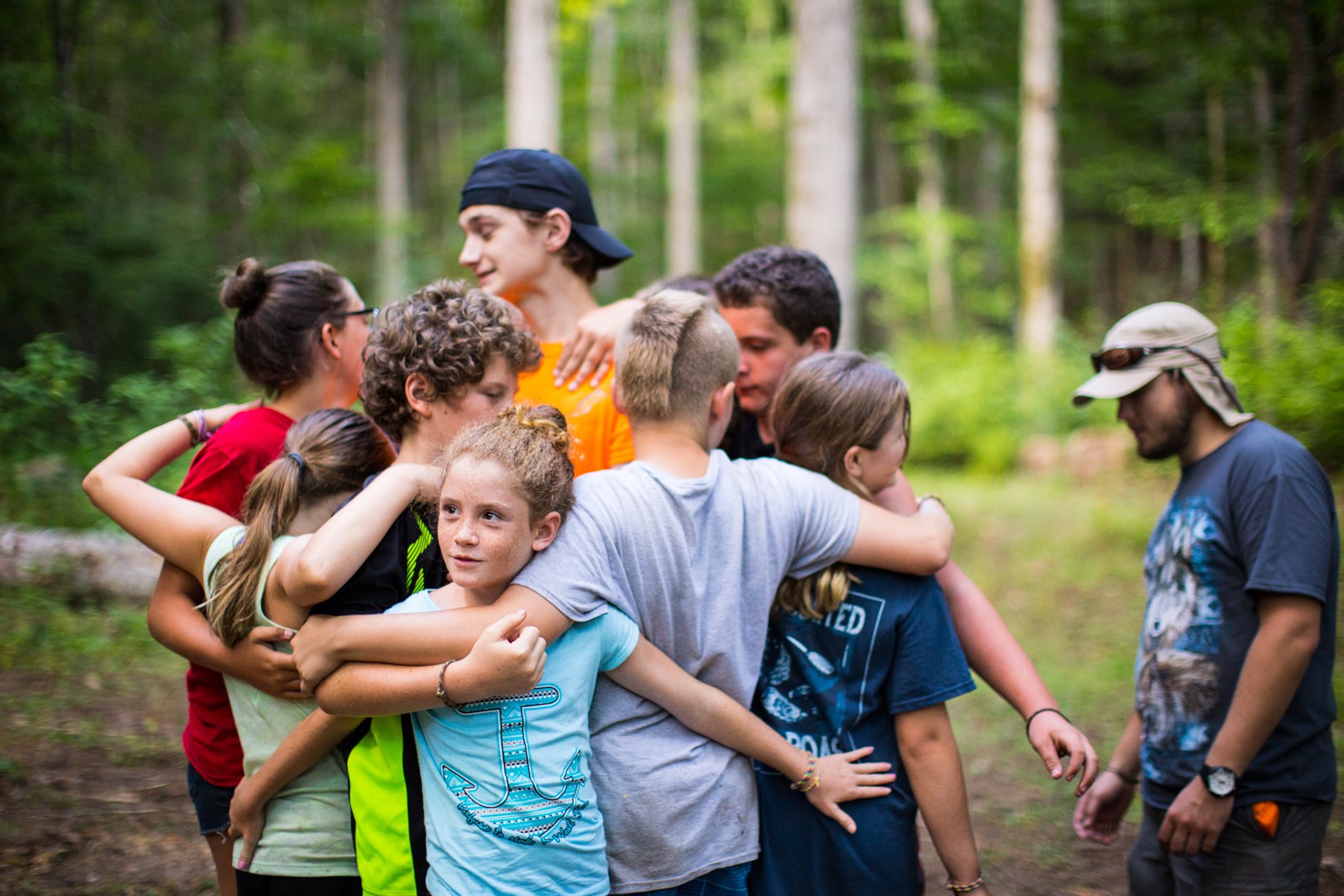 campers in a group hug camp activity