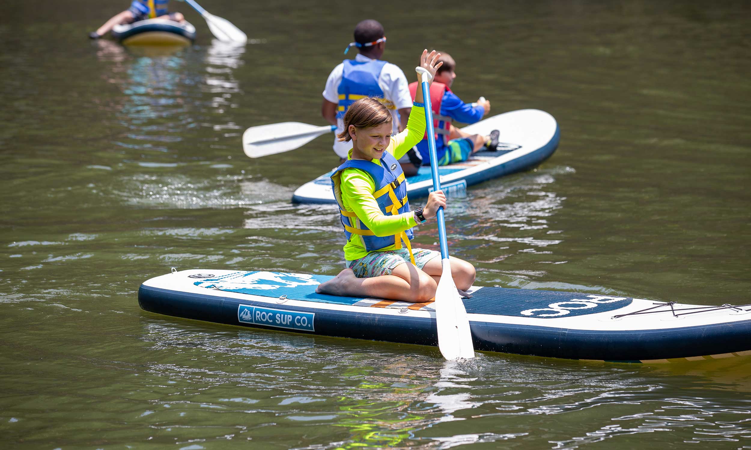 camper on a paddleboard paddling