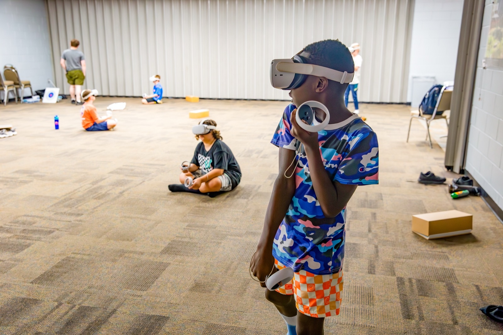 Campers using virtual reality headsets and controllers