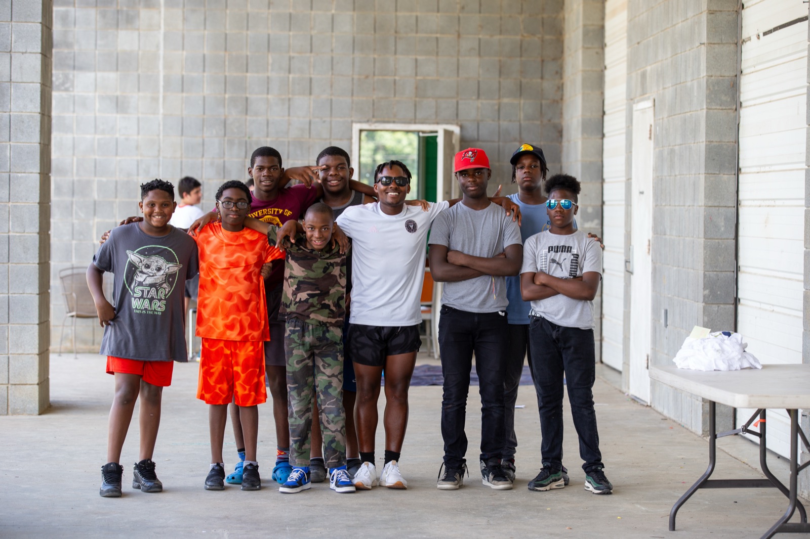 Group of campers posing together, arms around each other