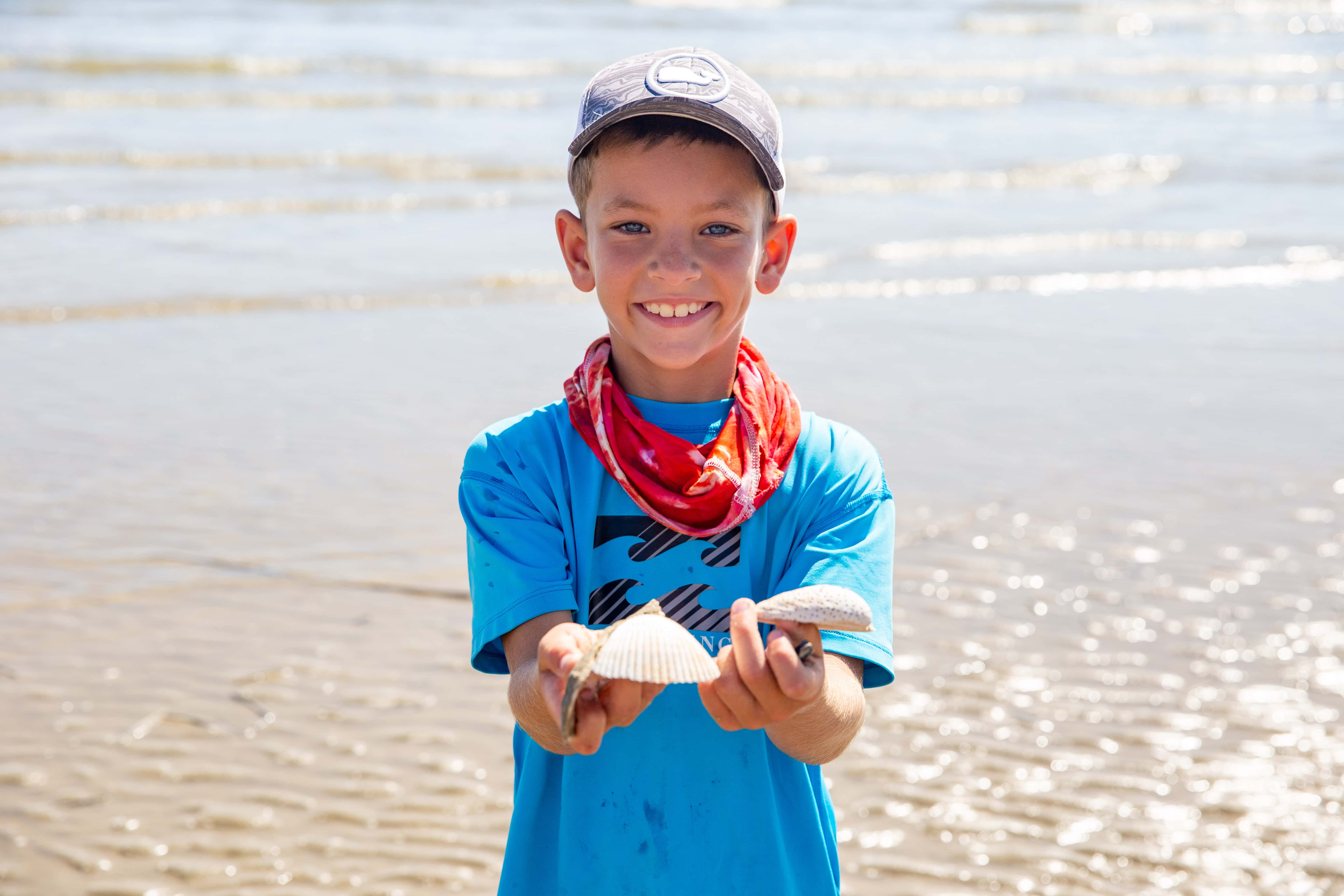 Boy holding seashell 